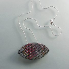 S349 This oval pendant has a random, mainly pink and orange mosaic style pattern. It is suspended on an 46 cm (18 inches) snake chain. 