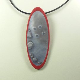 S377 silver patterned and red long oval pendant